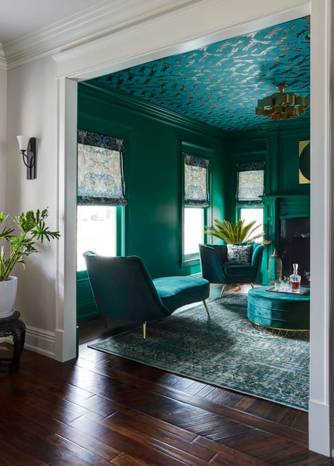 A view from an anterior room of an emerald green living room with accent ceilings - designed by Jasmin Reese Interiors, Chicago, USA. 