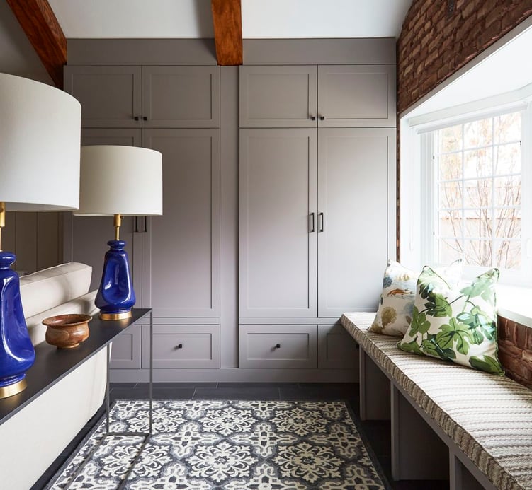 A mudroom with window seating designed by Jasmin Reese, Chicago: built-in cabinetry storage, and shoe storage under the window seat. 